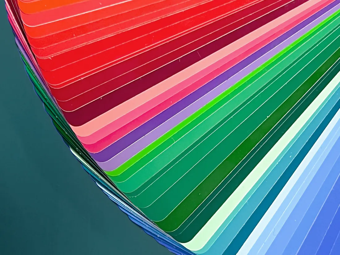 A fanned deck of paint colour swatches